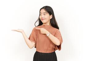 Showing and Presenting Product on Open Palm Of Beautiful Asian Woman Isolated On White Background photo