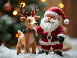 A Santa Claus doll in a red suit and a reindeer doll with a green scarf stand together on a white fluffy surface. Background includes a Christmas tree, evoking a festive and cheerful holiday scene. photo