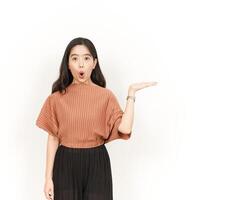 Showing and Presenting Product on Open Palm Of Beautiful Asian Woman Isolated On White Background photo