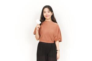 Showing Blank Credit or Bank Card Of Beautiful Asian Woman Isolated On White Background photo