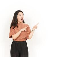 Showing Product and Pointing Side Of Beautiful Asian Woman Isolated On White Background photo