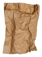 Empty crumpled brown paper bag on isolated background photo