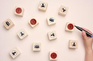 Wooden cubes with staff and goals, search for target audience photo