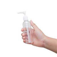 A hand holding a small bottle of hand sanitizer photo