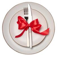 Empty white round plate, fork and knife on isolated background photo