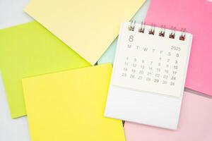 Simple desk calendar for AUGUST 2025 with Sticky note. Calendar concept with copy space. 2025 AUG calendar. photo