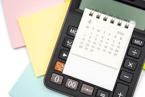 Simple desk calendar for APRIL 2025 on calculator. Calendar concept with copy space. 2025 APR calendar. photo