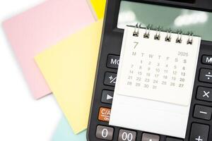 Simple desk calendar for JULY 2025 on calculator. Calendar concept with copy space. 2025 JUL calendar. photo