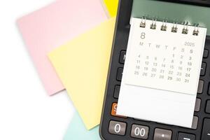 Simple desk calendar for AUGUST 2025 on calculator. Calendar concept with copy space. 2025 AUG calendar. photo