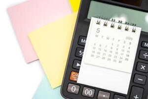 Simple desk calendar for MAY 2025 on calculator. Calendar concept with copy space. 2025 MAY calendar. photo