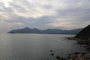 The scenery of the coast in Shenzhen is beautiful, with mountains and seawater visible on both sides photo