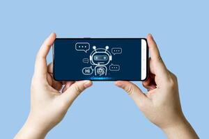 Close-up view of hand using online chat with robot on smartphone for online customer service by intelligent digital AI Chatbot application. photo