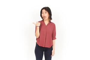 Showing Product and Pointing Side Using Thumb Of Beautiful Asian Woman Isolated On White Background photo