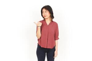 Showing Product and Pointing Side Using Thumb Of Beautiful Asian Woman Isolated On White Background photo
