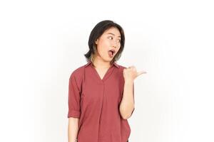 Showing Product and Pointing Side Using Thumb Of Beautiful Asian Woman Isolated On White Background photo