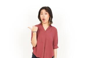 Showing and Pointing Side Product With Thumb Of Beautiful Asian Woman Isolated On White Background photo