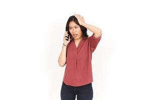 Make a Phone Call Using smartphone with angry face Of Beautiful Asian Woman Isolated On White Background photo