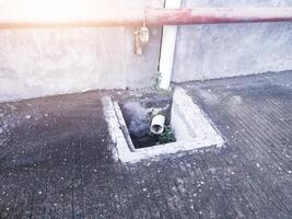 Control reservoir for draining water from building roof gutters. photo