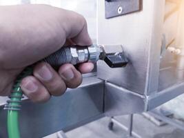 The hand man Connect to quick couplers in air pneumatic system on the manchinery. photo