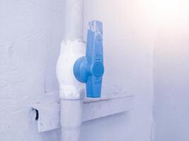 Valve gate for water pipe on the building wall. photo