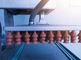 The suction cups eggs on the poultry hatchery machine for eggs candling and selection. Actuator pneumatic system on the Automatic eggs candling machine.Hatchery technology. photo