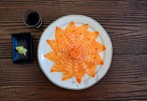 Slices of raw Salmon sashimi with wasabi and soy sauce photo