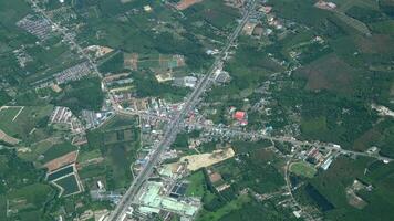 City view from jet plane with farming area. video
