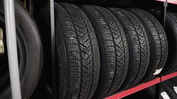 Car tires and wheels at warehouse in tire store. Different tires in an auto parts store video