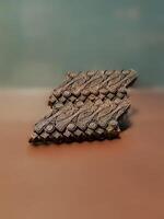 A close up of a Javanese batik copper stamp with an intricate geometric pattern. photo