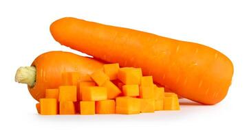 Fresh orange carrot roots with slices or pieces in cube shape and crossing in pile isolated on white background with clipping path photo
