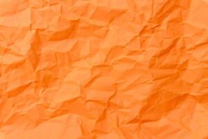 Top view and full frame photo of wrinkled or crumpled orange stencil paper used as crumpled orange paper background in art work
