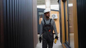 Windows installer in uniform walking with tools near modular home video