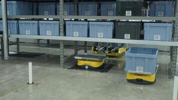 Demonstration of Smart warehouse management system with robotic handling system. Automated robotic tote arranging distribution product stock on shelf in modern factory. AI Technology Logistic concept. video