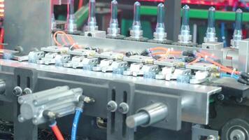 Demo making of PET or drinking water plastic bottle such as PET preform before automate heat blowing and shaping in molding machine and other process of making plastic bottles. Drinking water industry video