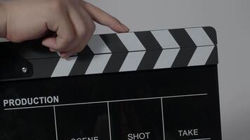 Close up hand holding empty film slate and clapping in front of camera. video