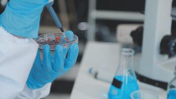 Scientist analyze biochemical samples in advanced scientific laboratory. Medical professional use dropper mix microbiological developmental of viral. Biotechnology research in science lab. cosmetic video