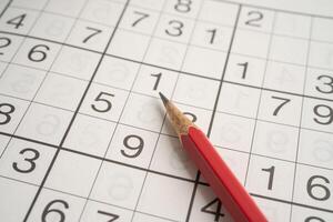 Sudoku puzzle game playing to challenge brain. photo