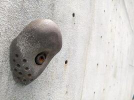 a metal object on the side of a climbing wall photo
