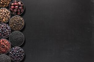 Dark spices on blackboard with space for food recipe. background of condiments for labels or site caps photo