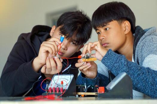 students are conducting experiments on basic electrical circuits. Concept of science classroom, learning science, science skills, learning, science experiments. photo