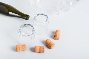 Alcoholism concept, empty glasses and bottles on grey background photo