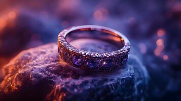 A ring with a stone on top of a rock photo