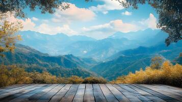A beautiful mountain view with a wooden deck overlooking the mountains photo