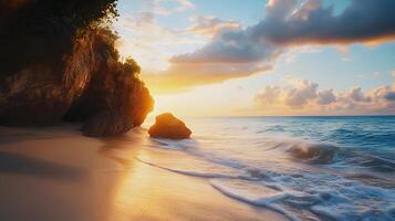 A beautiful beach with a large rock in the foreground photo