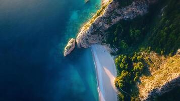 A beautiful beach with a rocky cliff in the background photo