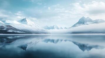 A mountain range is reflected in the water of a lake photo