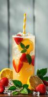 Refreshing summer drink with strawberries and lemons served over ice in a tall glass photo