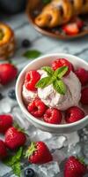Sweet summer dessert featuring raspberry ice cream in a bowl with fresh berries and mint leaves on a table photo