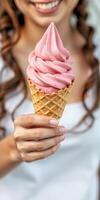 Enjoying a delicious strawberry ice cream cone on a sunny day in the park during summer photo