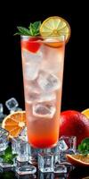 Refreshing fruit cocktail with ice served in a tall glass, garnished with mint and citrus slices photo